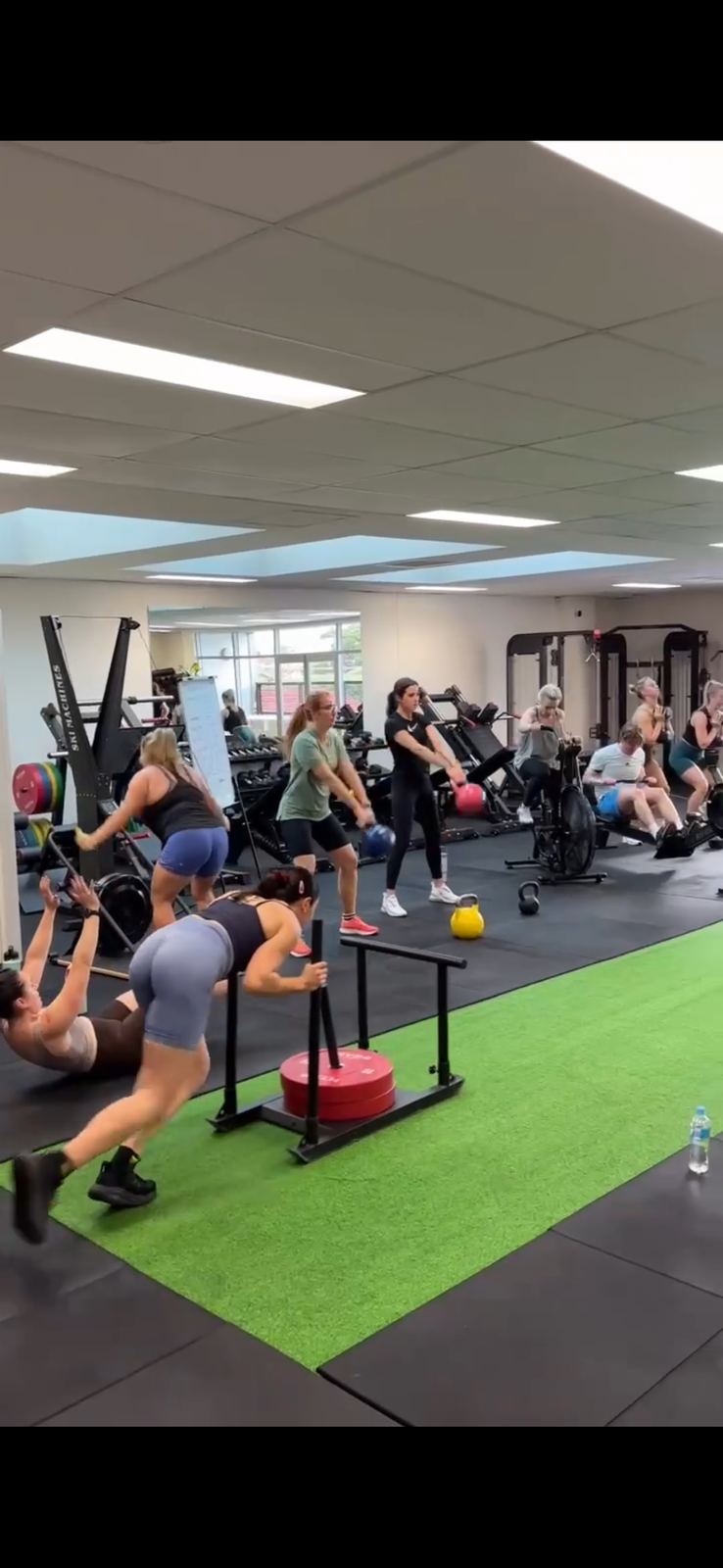 Members following individual programs in the gym